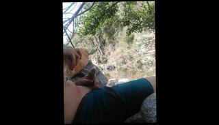 Watch the video about Boy playing with himself in a condom near a river