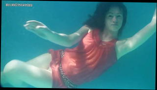 Watch the video about Red dressed mermaid Rusalka swimming in the pool