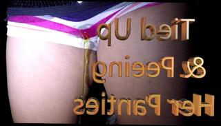 Watch the video about Tied Up & Peeing her Panties