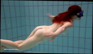 Watch the video about Big tits brunette Mia underwater naked