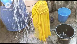 Watch the video about Indian house wife bathing outside