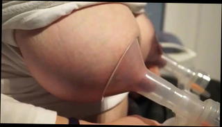 Watch the video about Chubby brunette pumps milk from her tits