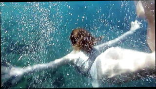 Watch the video about Swimming gracefully naked underwater