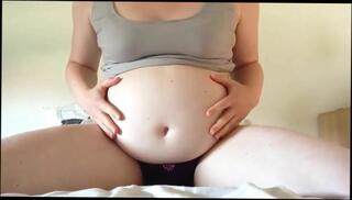 Watch the video about Hot pregnant belly close up