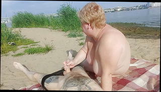 Watch the video about Sucking cock and jerking off on a public beach