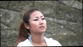 Watch the video about Pretty young brunette takes a walk on the beach